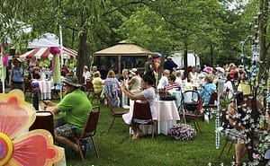 Picture of people sitting in a garden for the Platinum Jubilee Family Fun Weekender At Reuthe's The Lost Gardens of Sevenoaks. For Queen’s Platinum Jubilee Events In Kent