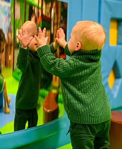 Baby playing with a mirror at the indoor play area Kids Bright House in Ramsgate